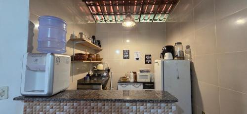 a kitchen with a counter top with a refrigerator at Refúgio das Gameleiras in Monte das Gameleiras