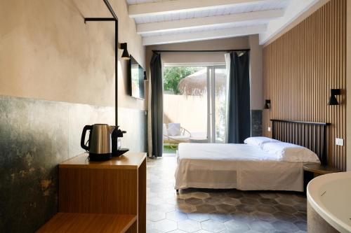 a hotel room with a bed and a bathroom at I Giardini di Cattaro - History & Comfort in Bari