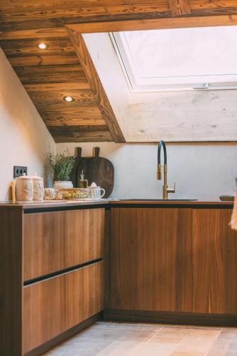 a kitchen with a sink and a skylight at Chalet Hideaway Alpi in Garmisch-Partenkirchen