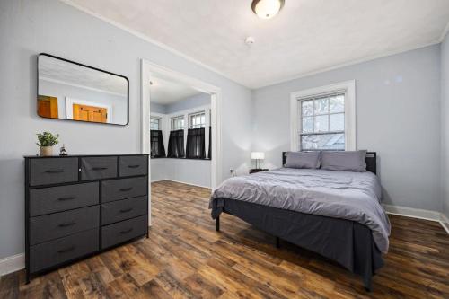 a bedroom with a bed and a dresser and a mirror at Comfortable Private Room | Shared Bath & Kitchen in Peoria