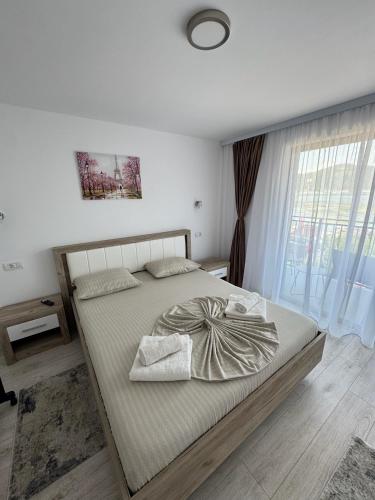 a bedroom with a bed and a large window at CasaA&B in Dubova