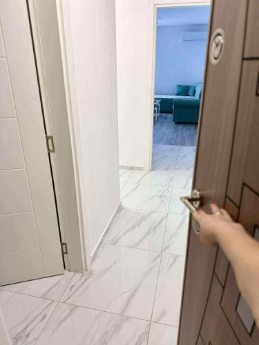 a person opening a door to a room at Bella LUX in Modriča