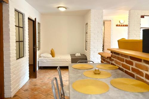 a room with a table and chairs and a bed at Pod Wzgórzem Bed & Breakfast in Frombork
