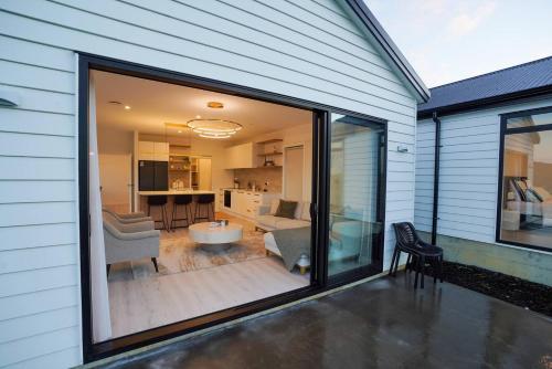 a large sliding glass door on a house at Northland Nest By Aotearoa Escapes in Whangarei