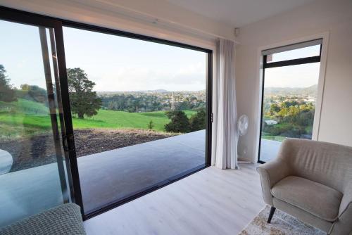 a living room with a large sliding glass door at Northland Nest By Aotearoa Escapes in Whangarei