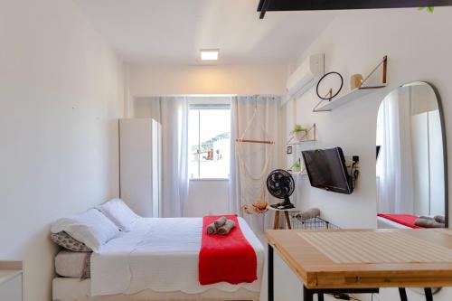 a small bedroom with a bed and a table at 360 Botafogo Belair By SUHCasa in Rio de Janeiro