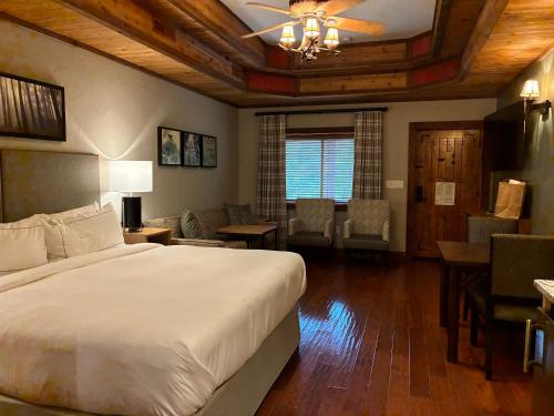 a bedroom with a large bed and a living room at Stonewater Cove in Shell Knob