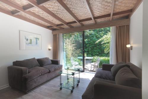 a living room with two couches and a large window at Hotel Acacias de Vitacura in Santiago