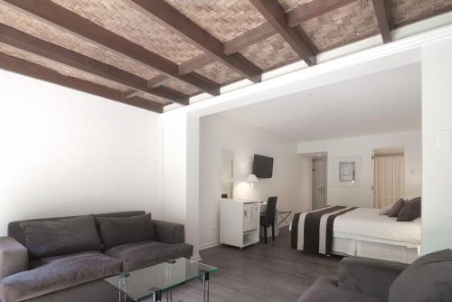 a living room with a bed and a couch at Hotel Acacias de Vitacura in Santiago