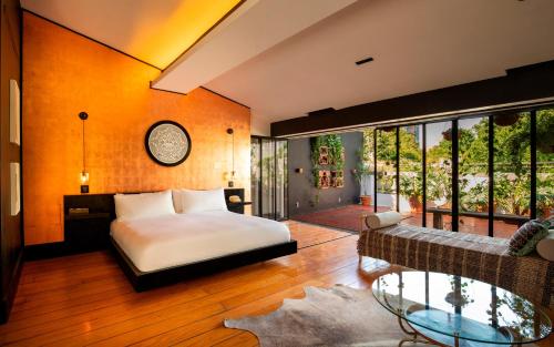 a bedroom with a bed and a large window at La Valise Mexico City, member of Small Luxury Hotels in Mexico City