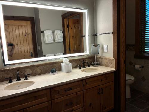 a bathroom with two sinks and a large mirror at Stonewater Cove in Shell Knob