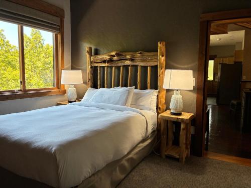 a bedroom with a large white bed with two lamps at Stonewater Cove in Shell Knob