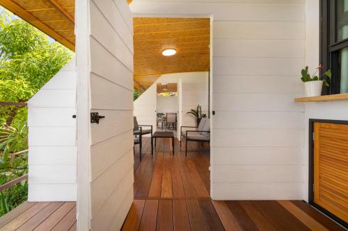 an open door leads to a dining room with white siding at TERA ORA TORU - Lodge and sea view in Papeete