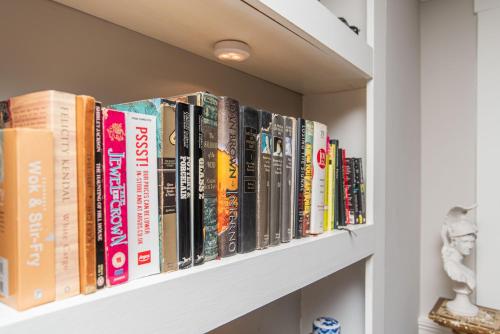 a row of books on a shelf at New England Scholar style retreat in Providence! in Providence
