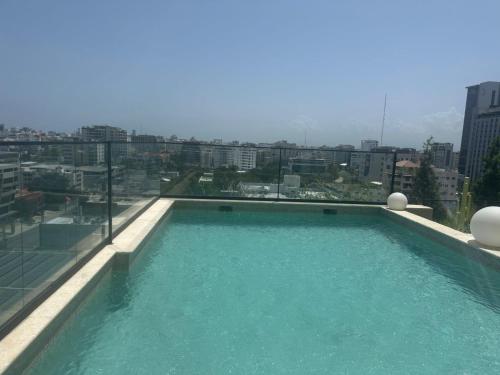 a swimming pool on the roof of a building at PIANTINI APARTAMENTO DE LUJO Piscina en el top in Santo Domingo