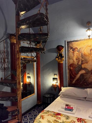 a bedroom with a bed and a painting on the wall at Domus Almapetra ai Fori Imperiali in Rome