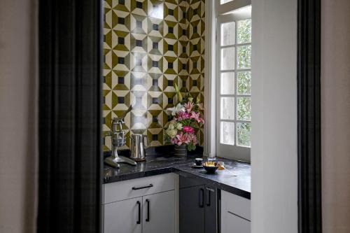 a kitchen with a black counter top and a window at La Valise Mexico City, member of Small Luxury Hotels in Mexico City
