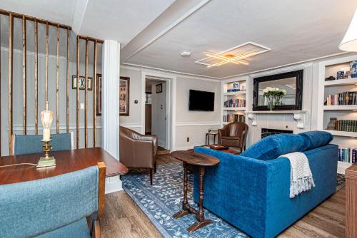 a living room with a blue couch and a table at New England Scholar style retreat in Providence! in Providence