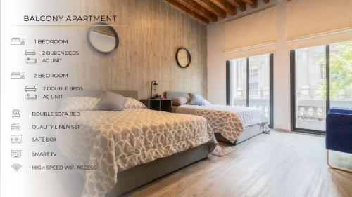 a bedroom with two beds and a wall with signs at 105 Centrico Zocalo apt 2Bdrm 2bath AC Rooftop in Mexico City