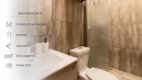 a bathroom with a toilet and a sink and a shower at 105 Centrico Zocalo apt 2Bdrm 2bath AC Rooftop in Mexico City