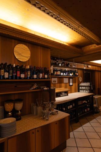 a kitchen with a bar with bottles of wine at Hotel Marlingerhof in Marlengo