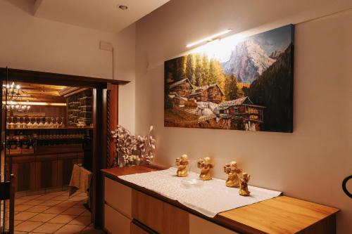 a wine tasting room with a painting on the wall at Hotel Marlingerhof in Marlengo