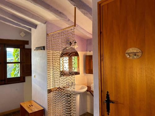 a bathroom with a shower with a toilet and a sink at Masia d'Els Plans in Vidrá