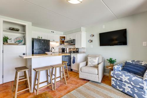 a kitchen and living room with a couch and a table at Carolina Beach Condo with Marina View, on Boardwalk in Carolina Beach