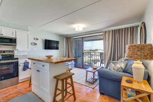 a kitchen and living room with a couch and a table at Carolina Beach Condo with Marina View, on Boardwalk in Carolina Beach