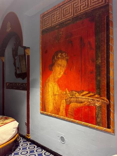a painting of a woman on a wall at Domus Almapetra ai Fori Imperiali in Rome