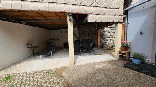 a patio with chairs and a table in a building at Rekreační domek Podmlýnská 232 in Rožmitál pod Třemšínem