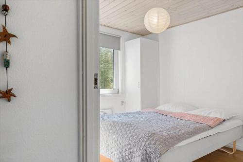 a white bedroom with a bed and a window at 535-Thisted-Molgaardsvej-75 in Thisted