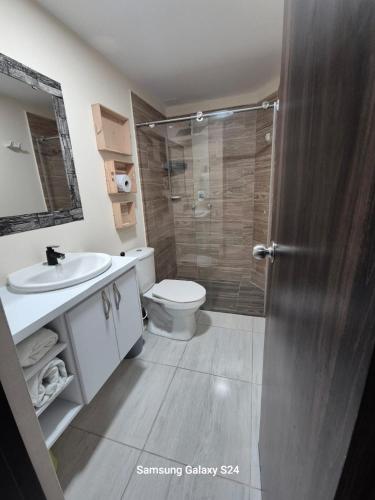 a bathroom with a shower and a toilet and a sink at Club residencial santafe in Cartago
