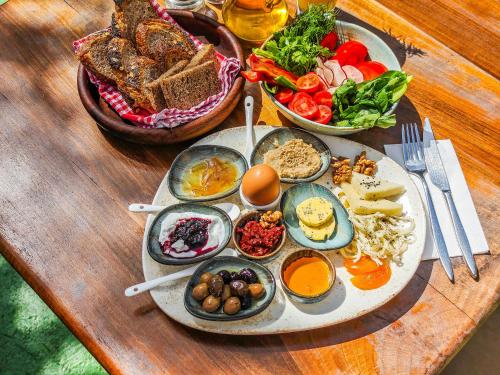 a table with a tray of breakfast foods on it at Banana Alaçatı Food & Stay - Adults Only in Alacati