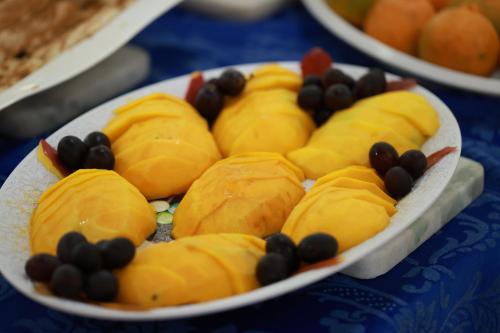 a plate of food with fruit on a table at Hot Star Thermas Hotel in Caldas Novas
