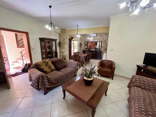 a living room with a couch and a coffee table at Rosmarino in Kissamos