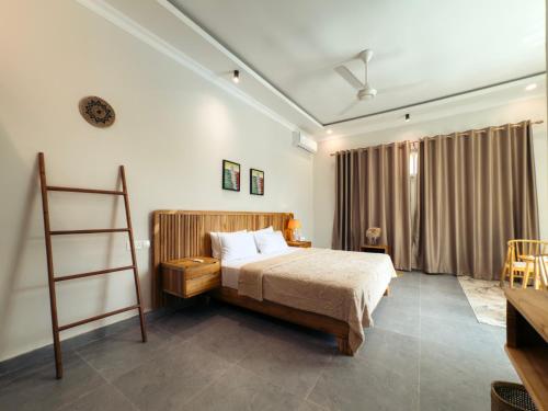 a bedroom with a bed and a ladder in it at Twin Villa Zulia by Zanzibar Stays - Private Pool Villa Jambiani in Jambiani