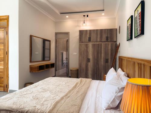 a bedroom with a large bed and a television at Twin Villa Zulia by Zanzibar Stays - Private Pool Villa Jambiani in Jambiani