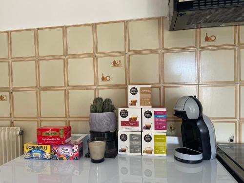 a counter top with a coffee maker and boxes on it at A 2 Colli dal Mare in Varazze