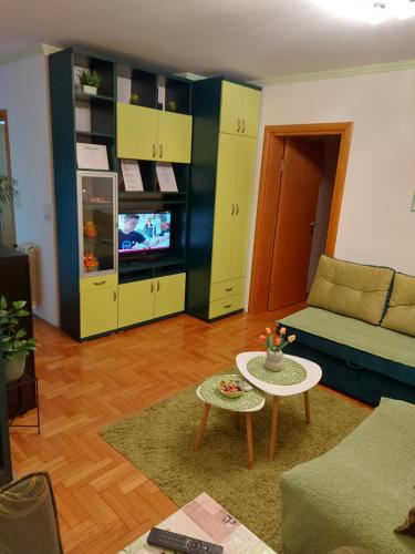 a living room with a couch and a table at stancicmilena in Požarevac