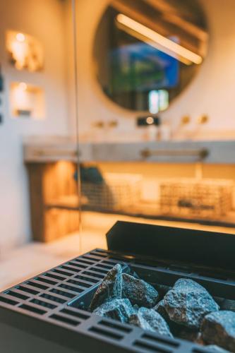 a grill with a bunch of rocks on it at Chalet Hideaway Alpi in Garmisch-Partenkirchen