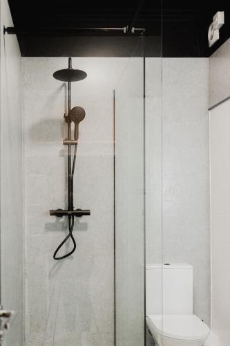 a glass shower in a bathroom with a toilet at The Yorkshire Unicorn in Skipton
