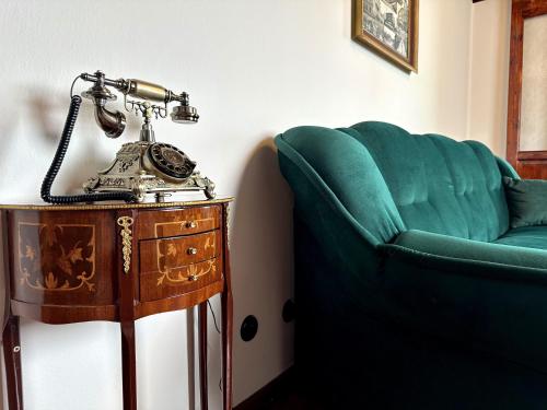 a telephone sitting on a table next to a couch at Hotel Velká Klajdovka in Brno