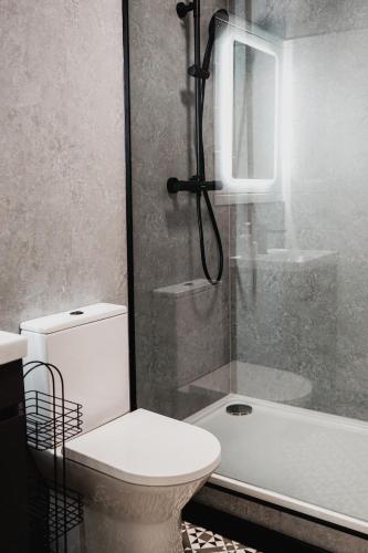 a bathroom with a shower and a toilet and a tub at The Yorkshire Unicorn in Skipton