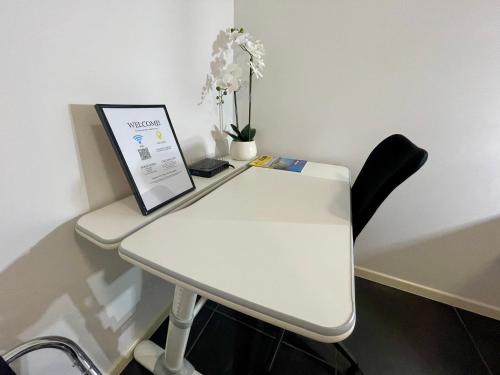 a white desk with a chair and a picture on it at Private unit in Whitehaven Crescent in Cannonvale