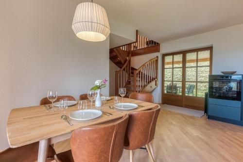 a dining room with a wooden table and chairs at ELA Apartments Traunkirchen in Traunkirchen