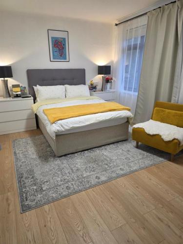a bedroom with a large bed and a chair at Bee hive in Manchester