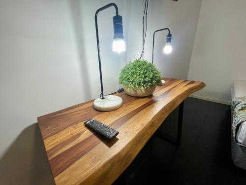 a desk with a keyboard and a lamp and a plant at Private unit in Whitehaven Crescent in Cannonvale