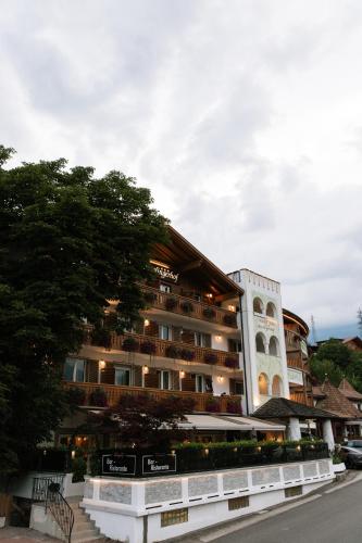 a hotel building with trees in front of it at Hotel Marlingerhof in Marlengo