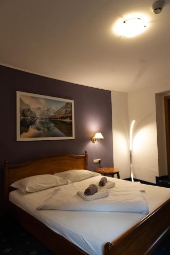 a bedroom with a bed with a towel on it at Hotel Marlingerhof in Marlengo